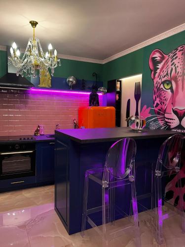 a kitchen with a bar with a tiger painted on the wall at Golden Fish in Jungle Jacuzzi Sauna Sarajevo in Sarajevo