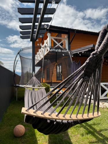 a hammock in front of a house at Weekend house in Verkhovyna