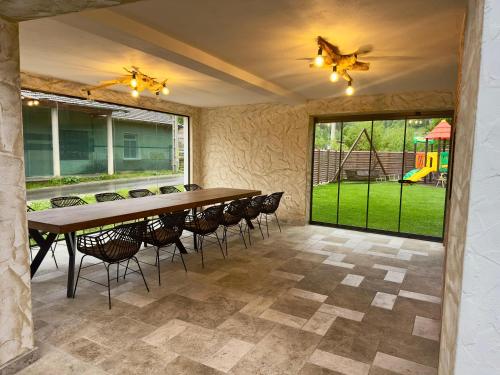 a large dining room with a table and chairs at Ranger Chalet in Moieciu de Sus