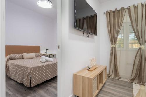 a bedroom with a bed and a window at Resort Circuito Sevilla in Carmona