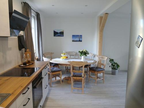 a kitchen and dining room with a table and chairs at Sarah's apartment NEW! in Mendig