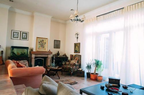 a living room with a couch and a table at Spacious 4 bedroom Luxury Villa with Lush Gardens Close to City & Beach in Alexandroupoli