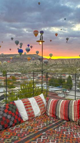 a room with a view of a city with hot air balloons at Gala Cave Cappadocia in Goreme