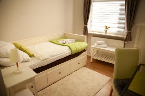 a small bedroom with a bed and a desk at WohnRaum Gäste- & Boardinghaus in Gusterath