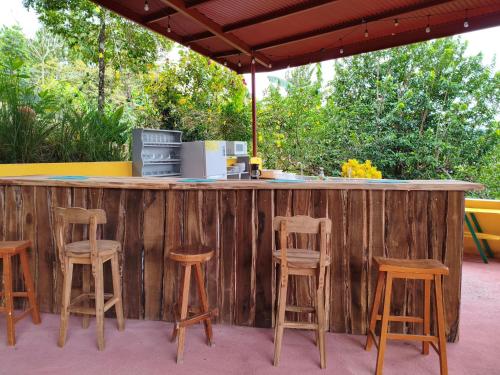 a bar with stools at a outdoor kitchen at Las Catalinas Ecológicas (El Maizal) in Antón