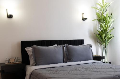 a bedroom with a bed with two plants at 2BR Near OHare and Transit Newly Furnished Modern in Chicago