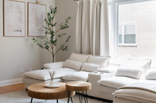 a living room with a white couch and a table at 2BR Near OHare and Transit Newly Furnished Modern in Chicago