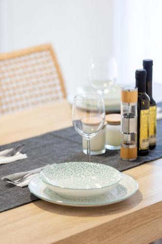 a plate and a wine glass on a table at SeaAuraApartment in Áyioi Apóstoloi