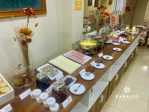 a table with many different types of food on it at Hoteles Paraiso CHICLAYO in Chiclayo