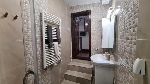 a bathroom with a sink and a toilet and a mirror at Town Square Loft Apartment in Braşov
