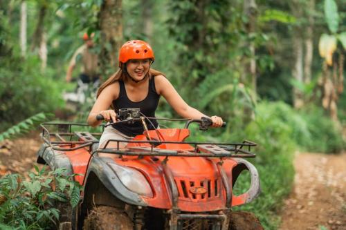 a woman riding a atv down a dirt trail at Ocotal Luxury Villa with Private Pool in Ocotal