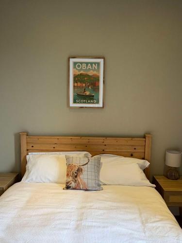 a dog sitting on top of a bed at Central Oban 2BR Short walk to Ferries and Harbour in Oban