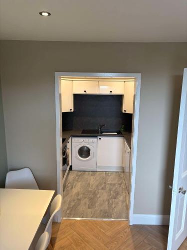 a kitchen with a washer and dryer in a room at Central Oban 2BR Short walk to Ferries and Harbour in Oban
