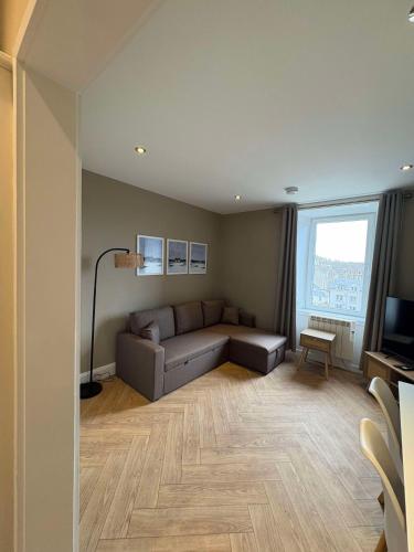 a living room with a couch and a television at Central Oban 2BR Short walk to Ferries and Harbour in Oban