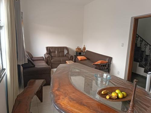 a living room with a table and a couch at Hostel do Papai 3 in Lavras