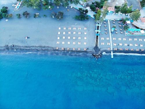 an aerial view of a building and the ocean at Bucak Apart Hotel Göcek & Beach in Göcek