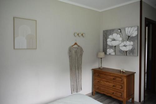 a bedroom with a bed and a wooden dresser at Villa de Mamoune in Martelange