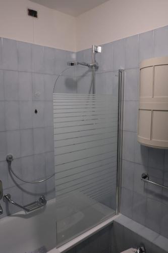 a shower with a glass door in a bathroom at Nervi, sea view in Genoa