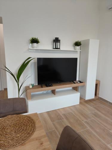a living room with a flat screen tv on a wall at Oltremare FRONTE SPIAGGIA in Ladispoli
