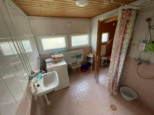 a bathroom with a sink and a shower at Hiitolantie 4 in Härmä