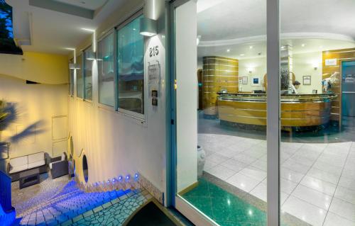 a lobby with a glass door with a pool in it at Residence Queen in Rimini