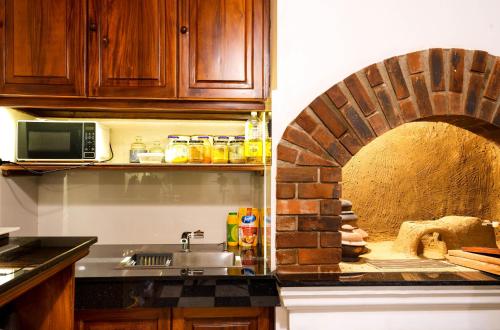 a kitchen with a brick oven in the wall at Villa 20 Fort in Galle