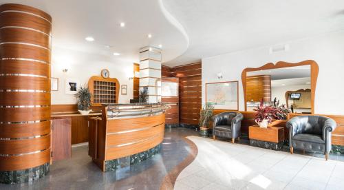 a waiting room with two chairs and a mirror at Residence Queen in Rimini