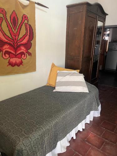 a bedroom with a bed and a painting on the wall at Casa Chica in Cafayate