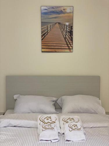 a bed with two white pillows and a pier at Bayt Hassan S18 - Fabulous Roof top 1 bedroom apartment in Hurghada