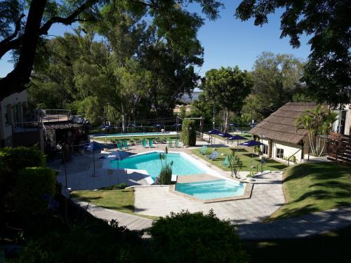 a large swimming pool in a yard with trees at Complejo Turistico Open Club in Paraná
