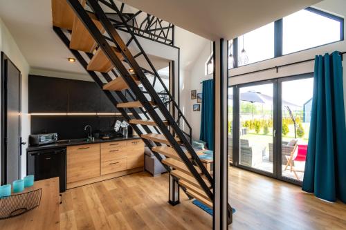 a kitchen with a spiral staircase in a house at Seaside Spokes in Wytowno