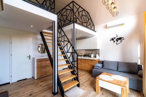 a living room with a staircase leading up to a loft at Seaside Spokes in Wytowno