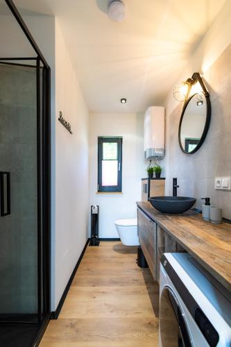 a bathroom with a sink and a mirror at Seaside Spokes in Wytowno