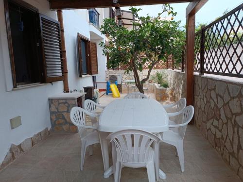 a white table and chairs on a patio at Appartamento G&G in San Vito lo Capo