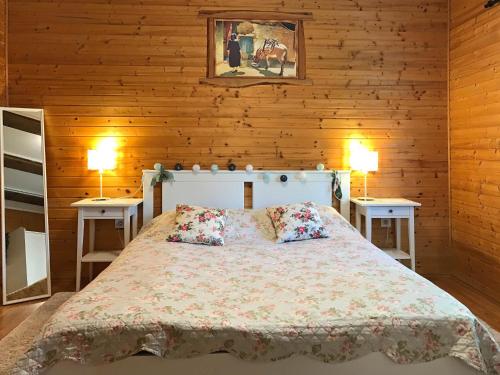 a bedroom with a large bed with two tables at Apartments Novela in Poljanak