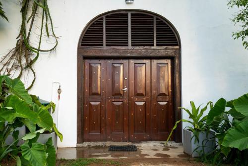 a wooden door with an arched window at Villa 20 Fort in Galle