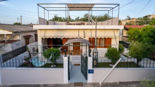 a house with a gate in front of it at Salamis Luxury Escape in Salamís