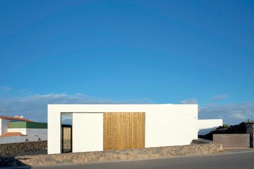 a rendering of a white building with a wooden door at Salty Villa by Aura Collection in El Roque