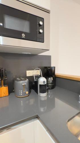 a kitchen counter with a toaster and a microwave at Ocean in Orio
