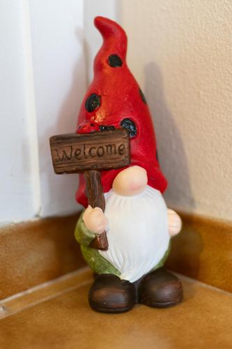 a gnome holding a sign that says welcome at Salamis Luxury Escape in Salamís