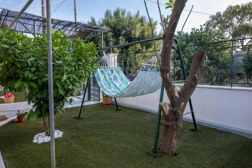 a hammock hanging from a tree on a balcony at Salamis Luxury Escape in Salamís