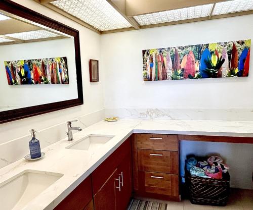 a bathroom with two sinks and a large mirror at Luana Kai A104 condo in Kihei