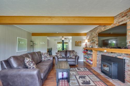 a living room with a couch and a fireplace at Peaceful and Private Franconia Home by Cannon! in Franconia