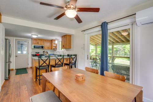 a kitchen with a wooden table and a ceiling fan at Peaceful and Private Franconia Home by Cannon! in Franconia