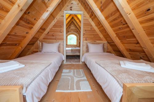 two beds in the attic of a log cabin at Wolf's Peak in Babljak