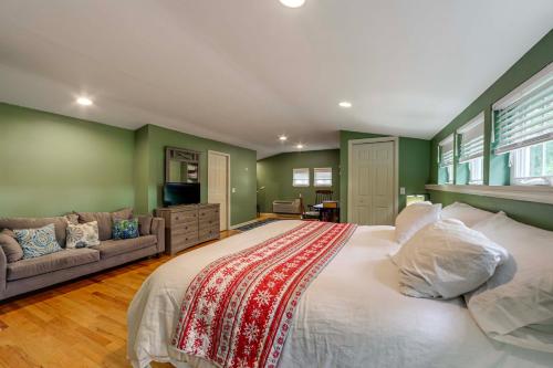 a bedroom with a large bed and a couch at 11 Mi to Oneida Lake Spacious Apt in Verona! in Verona