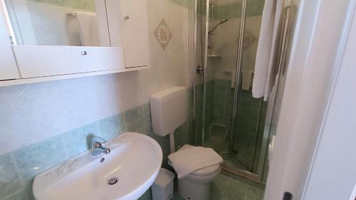 a bathroom with a sink and a shower and a toilet at Appartamenti Tina in Villa Restituta in Ischia