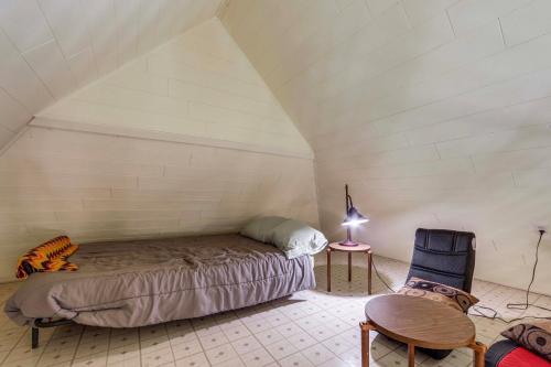 a bedroom with a bed and a chair in a room at 11 Mi to Oneida Lake Spacious Apt in Verona! in Verona