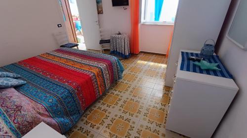 a bedroom with a bed and a floor at Appartamenti Tina in Villa Restituta in Ischia
