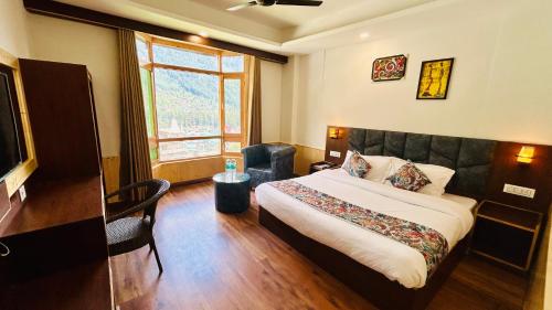 a hotel room with a bed and a window at Hotel Meadows & Hotel OceanGrass ! Rooftop Cafe ! Music ! Near To Mall Road in Manāli